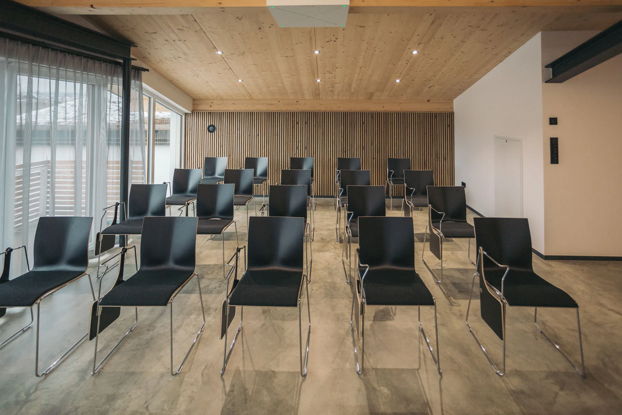 Seminar seating in the RiverRoom with rows of chairs under the wooden ceiling